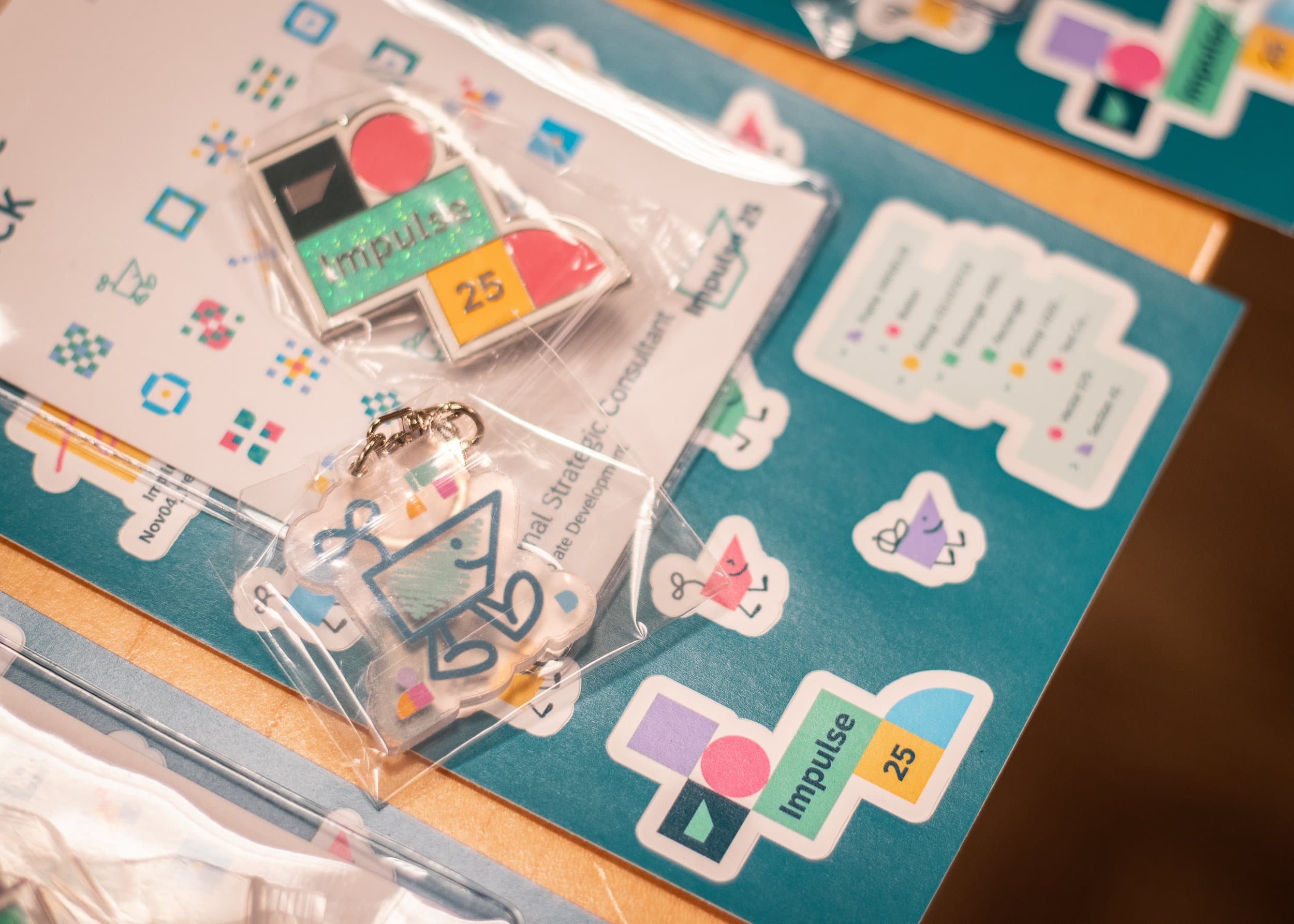 Close-up of Impulse 25 event stickers and badges