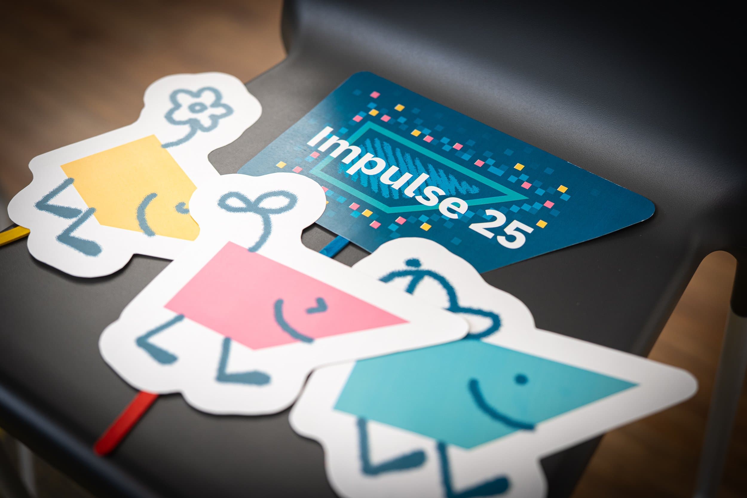 Impulse 25 event cutout signage on a table