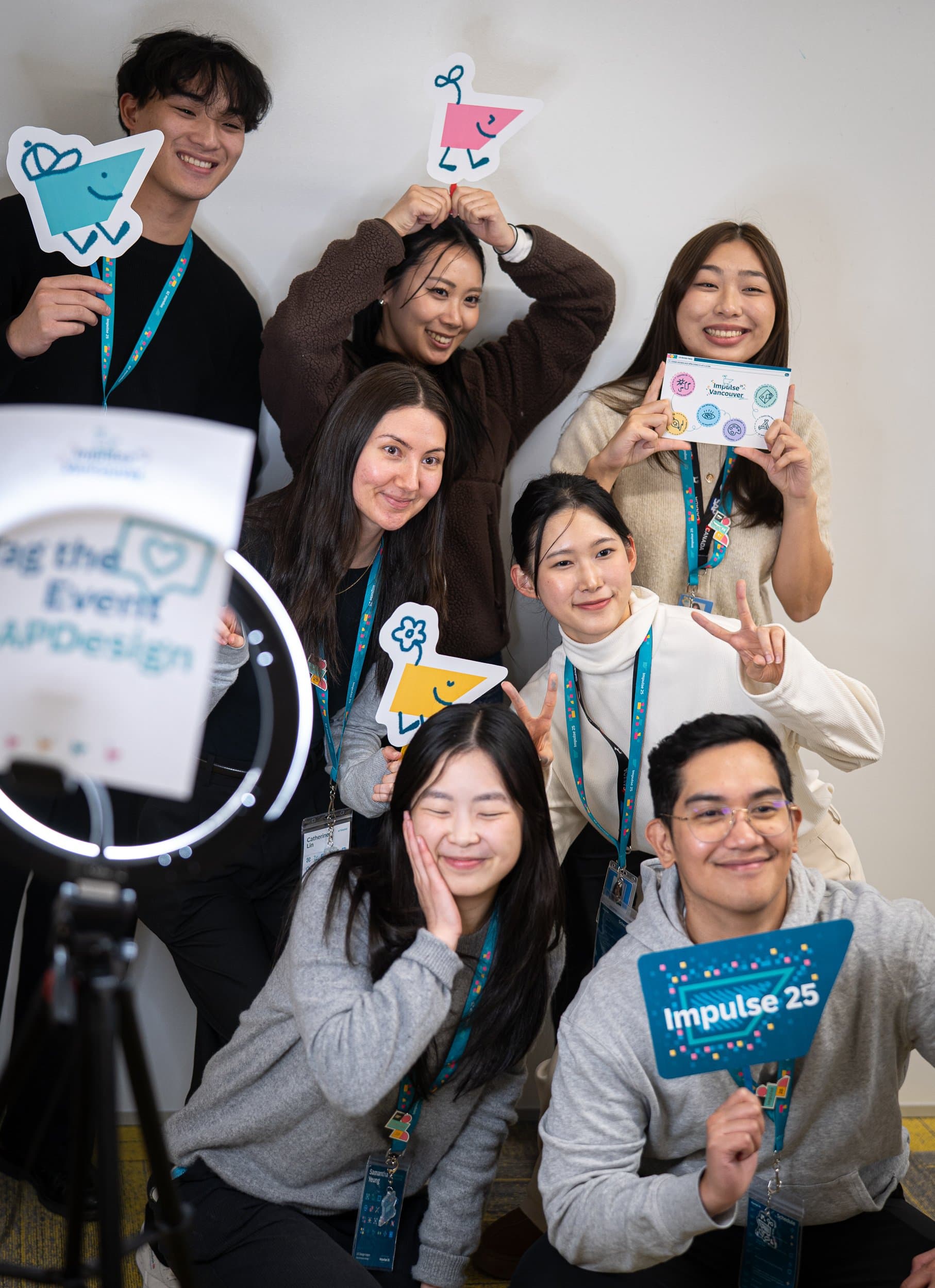 Group photo of the UX/UA intern team holding signage at Impulse