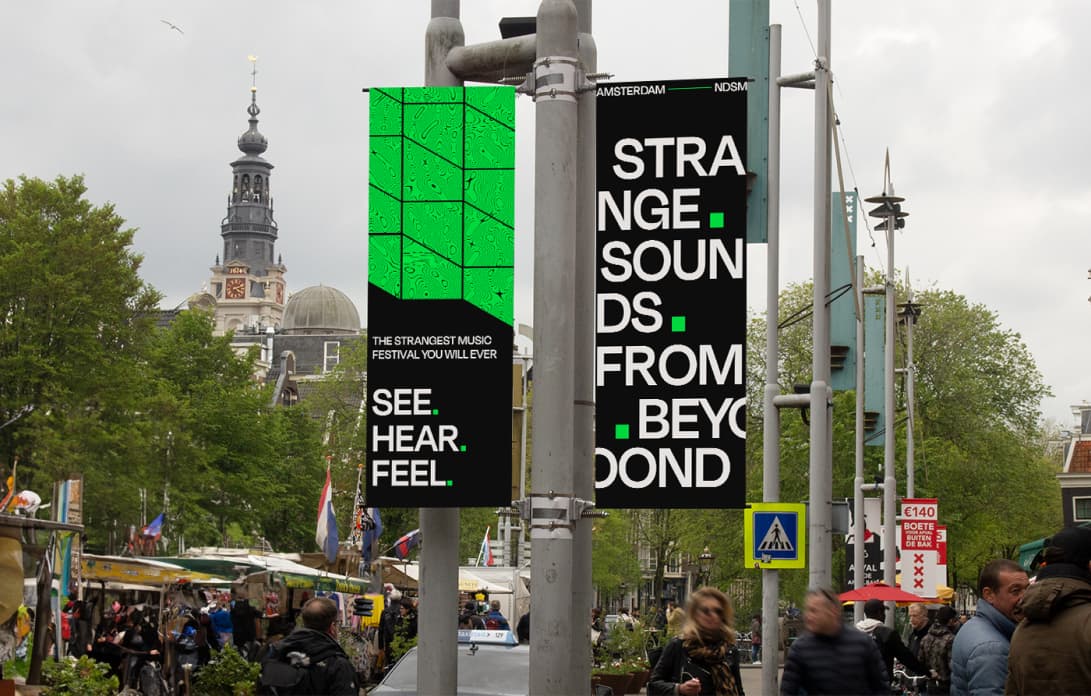 Street banners reading See Hear Feel and Strange Sounds From Beyond in Amsterdam