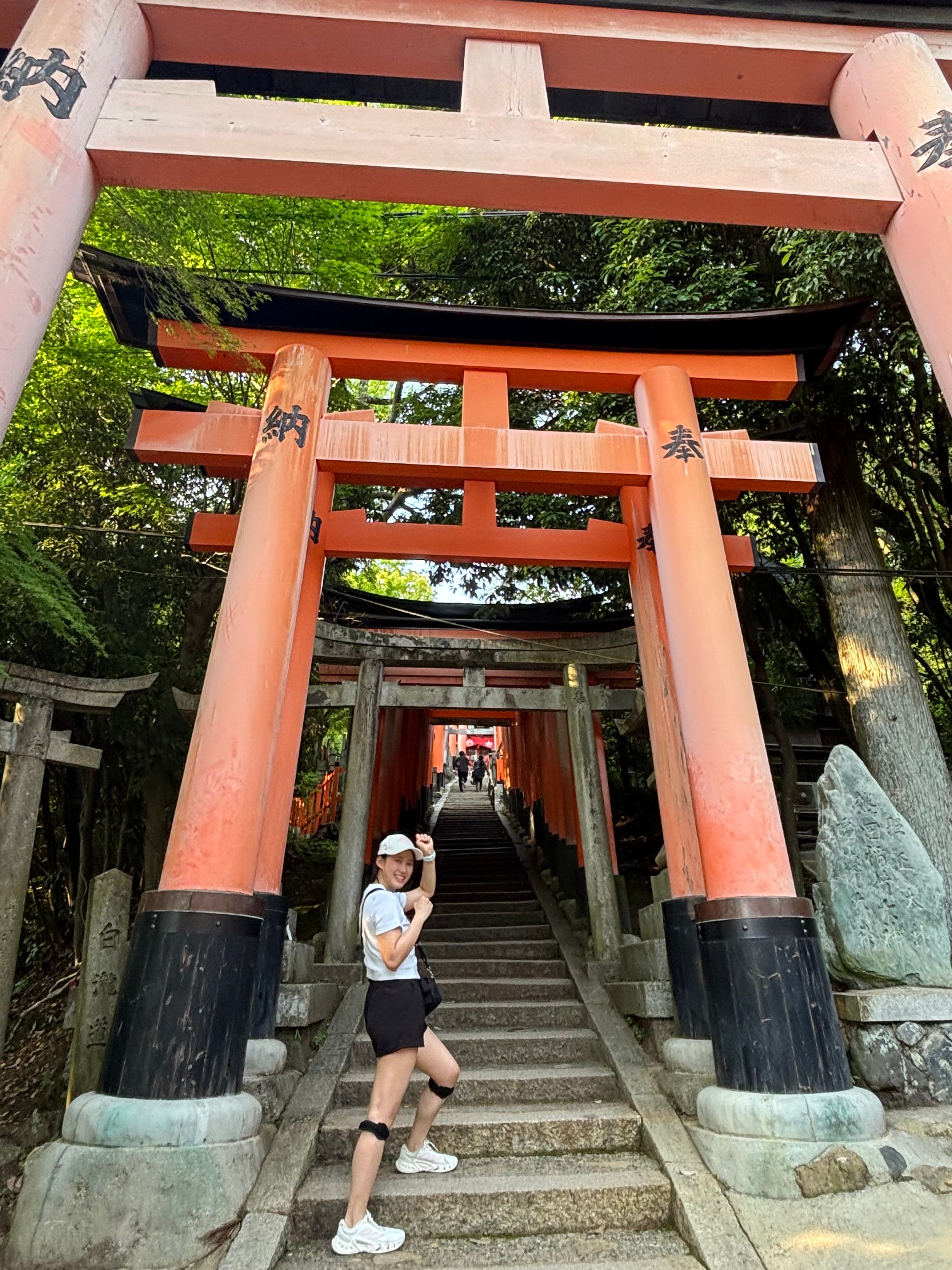 Reina standing beneath red torii gates