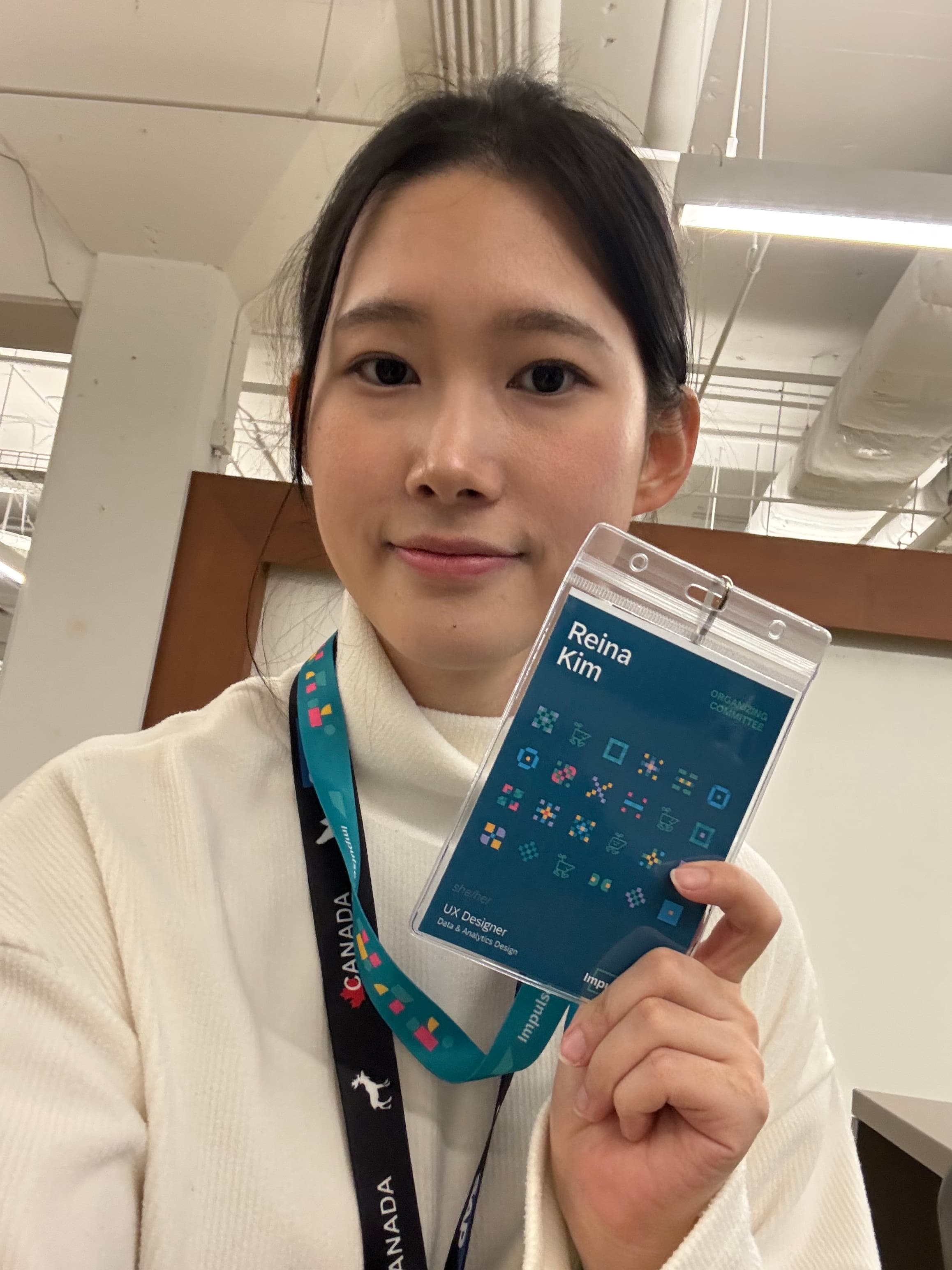 Reina holding a blue booklet